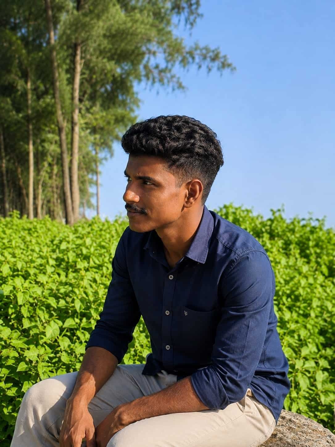 Best digital marketing specialist in Thrissur sitting outdoors in nature.